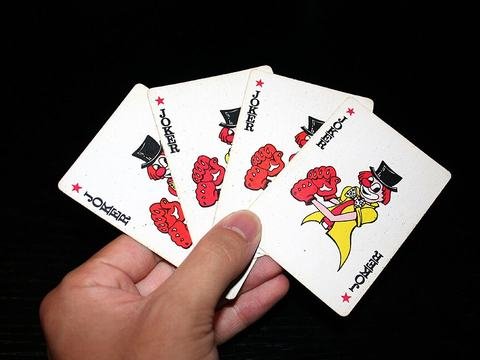 Joker playing cards in hand